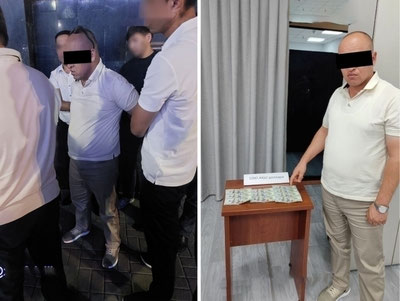 Image of 'In the capital, a "bribe-taking" tax official was caught with a thousand-dollar bribe.'