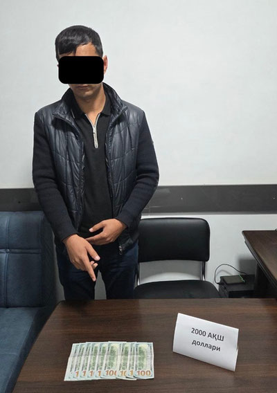 'Qarshi tumani yetakchi inspektori 2 ming dollar olgan vaqtida ushlandi'ning rasmi